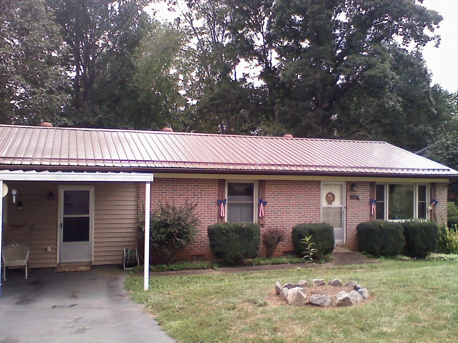 Bronze metal roof and carport on a brick ranch home — Roof Repair work by our crew in Atlantic Highlands